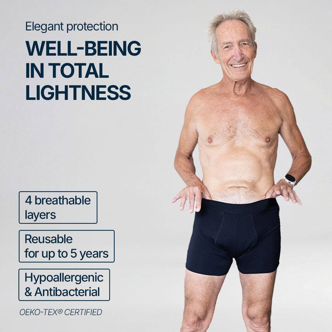 Smiling senior man wearing black absorbent boxer briefs for light bladder leaks, providing elegant everyday comfort, featuring 4 breathable layers, reusable for up to 5 years, hypoallergenic and antibacterial, OEKO-TEX certified for safe and reliable protection.