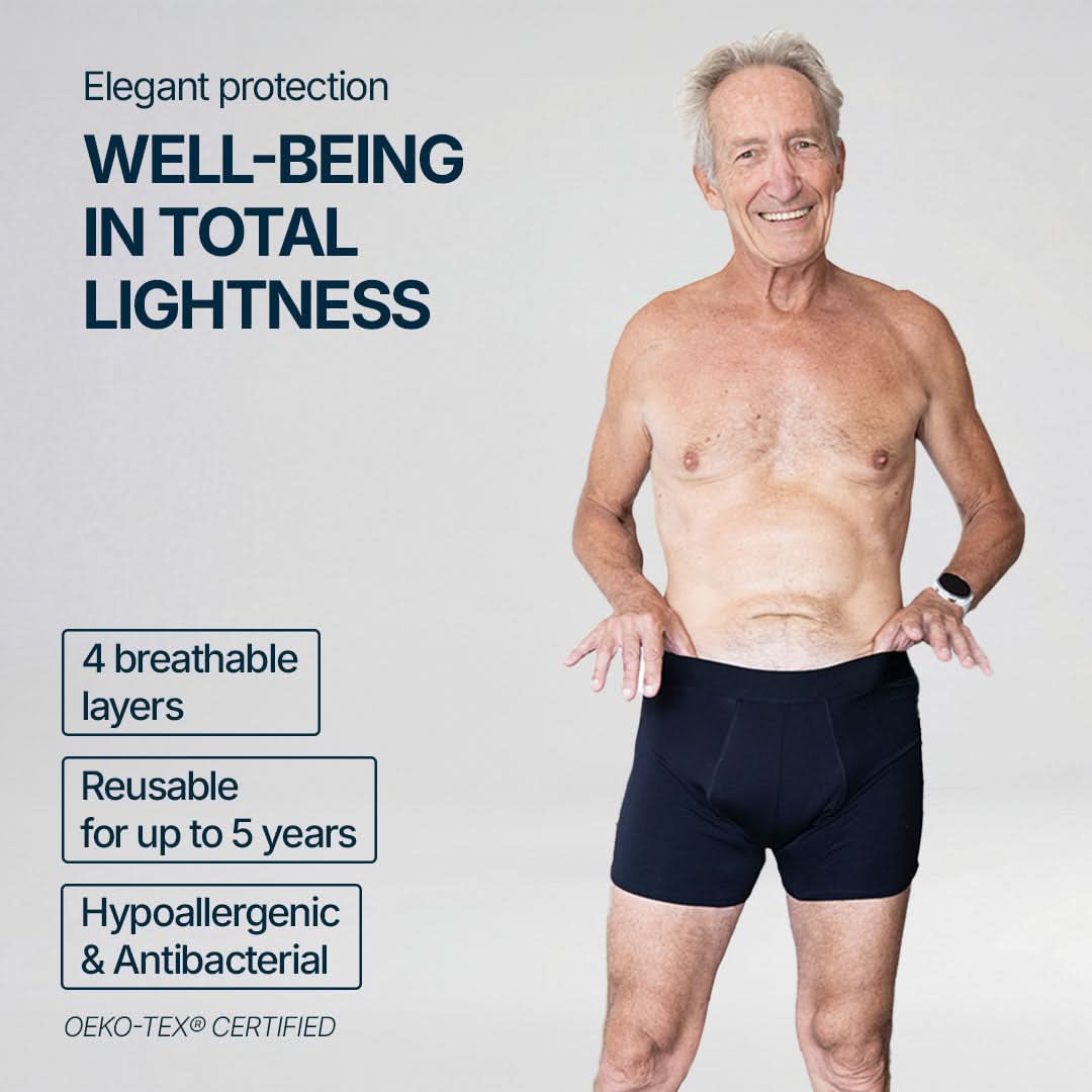 Smiling senior man wearing black absorbent boxer briefs for light bladder leaks, providing elegant everyday comfort, featuring 4 breathable layers, reusable for up to 5 years, hypoallergenic and antibacterial, OEKO-TEX certified for safe and reliable protection.