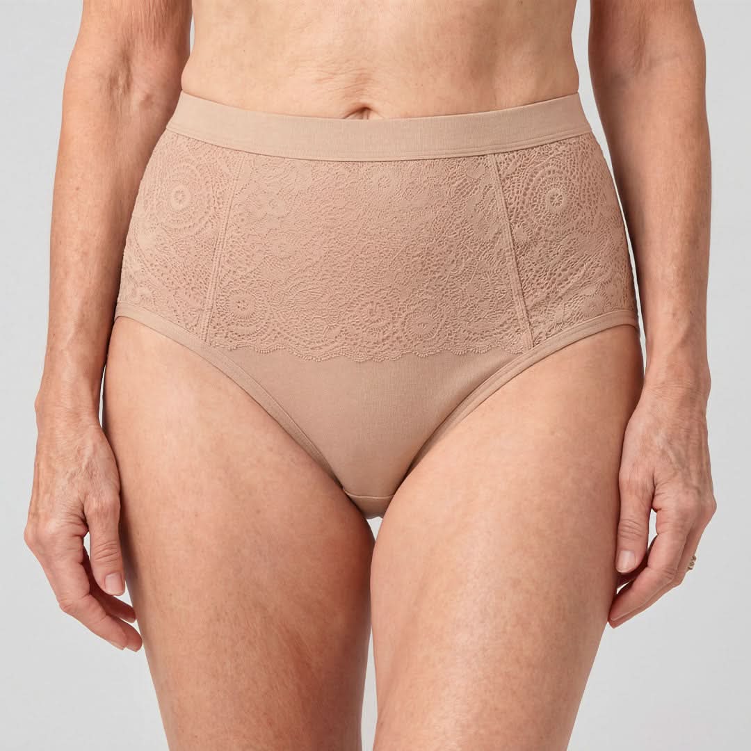 Woman wearing high-waisted beige absorbent underwear for female incontinence, featuring elegant lace detailing and comfortable support, a washable and discreet solution for light to moderate bladder leaks, providing effective odor control with no damp feeling.