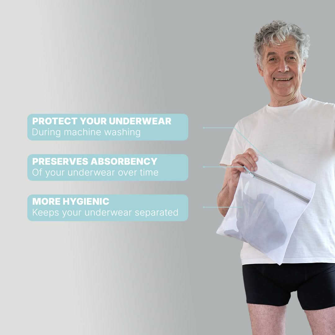 Senior man holding a mesh Orykas laundry bag with a zipper, designed to protect absorbent underwear in the washing machine, preserve their absorption capacity, and ensure more hygienic washing by keeping garments separate.