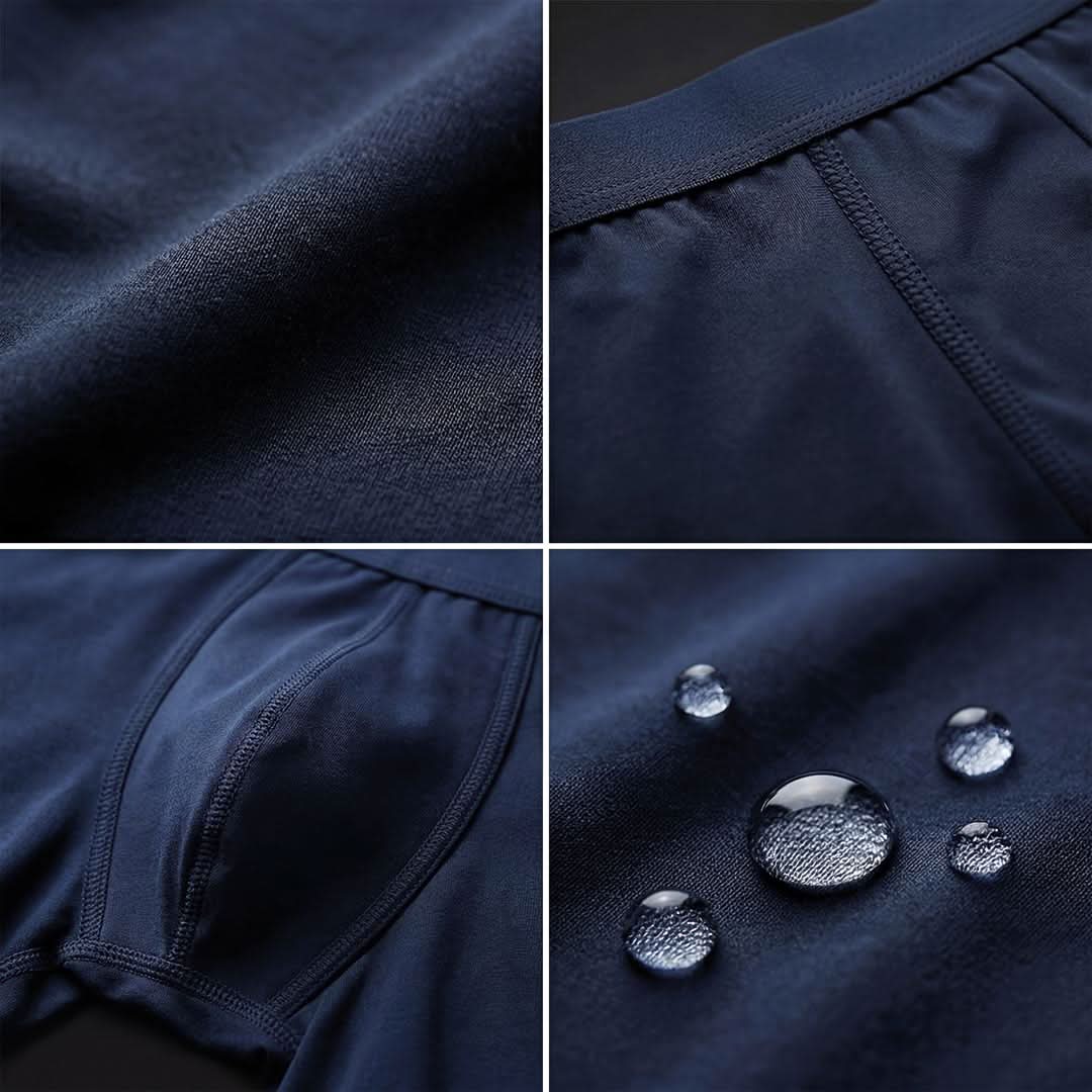Close-up of navy blue Orykas men's incontinence boxer briefs highlighting patchwork bamboo fiber absorption zone with discreet leak protection