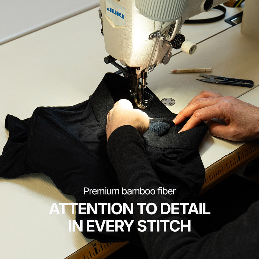 Manufacturing workshop with an industrial sewing machine assembling black Orykas boxer briefs made from premium bamboo fiber, highlighting precise stitching and meticulous attention to detail in every seam.